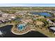 Aerial view of community pool, tennis courts, and lakefront at 328 Aria Dr, Nokomis, FL 34275