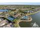 Aerial view of community with pool, tennis courts, and lake at 328 Aria Dr, Nokomis, FL 34275