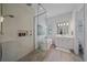 Bright bathroom features a soaking tub, glass shower, and white vanity at 328 Aria Dr, Nokomis, FL 34275