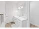 Bright bathroom with white vanity, quartz countertop and a large mirror at 328 Aria Dr, Nokomis, FL 34275