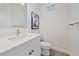 Clean half bath featuring modern fixture, sleek countertop, and framed art at 328 Aria Dr, Nokomis, FL 34275