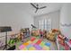 Playful bedroom with beanbag chairs, toys, and a shuttered window at 328 Aria Dr, Nokomis, FL 34275