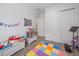 Playful bedroom featuring colorful floor tiles and a toy chest against the wall at 328 Aria Dr, Nokomis, FL 34275