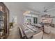 Open-concept dining area with modern chandelier, comfortable seating, and seamless flow into the living room at 328 Aria Dr, Nokomis, FL 34275