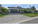 Front view of a single-story house with a paved driveway at 328 Aria Dr, Nokomis, FL 34275