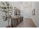 Bright foyer with tray ceilings, wood-look tile flooring, and a stylish console table at 328 Aria Dr, Nokomis, FL 34275