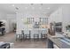 Modern white kitchen with large island, stainless steel appliances, and glass-front cabinets at 328 Aria Dr, Nokomis, FL 34275