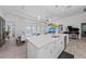 Modern white kitchen island with quartz countertop and stainless steel appliances at 328 Aria Dr, Nokomis, FL 34275