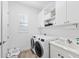 Clean laundry room with washer, dryer, and storage at 328 Aria Dr, Nokomis, FL 34275