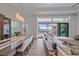 Bright living room and dining room with hardwood floors, a modern chandelier, and a view of the pool at 328 Aria Dr, Nokomis, FL 34275