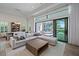 Bright living room featuring a large sectional sofa and sliding glass doors leading to a screened outdoor area at 328 Aria Dr, Nokomis, FL 34275