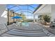 Relaxing pool area with covered patio, lounge chairs, and lake view at 328 Aria Dr, Nokomis, FL 34275