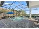 Inviting pool and patio with covered seating area at 328 Aria Dr, Nokomis, FL 34275