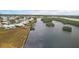 Aerial view of waterfront community with many homes and lush landscaping at 3608 Joyce Dr, Bradenton, FL 34208