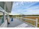 Screened porch overlooking the water with a gray deck at 3608 Joyce Dr, Bradenton, FL 34208