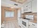 White kitchen with appliances and tiled floors at 3608 Joyce Dr, Bradenton, FL 34208