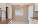 Kitchen with white cabinets, tiled floor, and a window at 3608 Joyce Dr, Bradenton, FL 34208