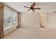 Living room with large window, ceiling fan and carpet at 3608 Joyce Dr, Bradenton, FL 34208