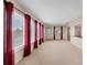 Spacious living room with neutral walls and red curtains at 3608 Joyce Dr, Bradenton, FL 34208