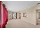 Living room with red curtains, window and access to kitchen at 3608 Joyce Dr, Bradenton, FL 34208