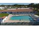 Community pool with lounge chairs and adjacent building at 3608 Joyce Dr, Bradenton, FL 34208