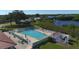 Community pool with surrounding patio and waterfront view at 3608 Joyce Dr, Bradenton, FL 34208