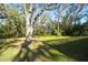 Private backyard with mature trees and grassy lawn at 3709 Wilderness W Blvd, Parrish, FL 34219