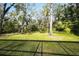 Spacious backyard with lush greenery and large trees at 3709 Wilderness W Blvd, Parrish, FL 34219