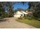 House's front view with a paved driveway and lush lawn at 3709 Wilderness W Blvd, Parrish, FL 34219