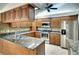 Kitchen with granite countertops, wooden cabinets, and stainless steel appliances at 3709 Wilderness W Blvd, Parrish, FL 34219