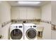 Laundry room with washer, dryer, utility sink, and ample cabinets at 3709 Wilderness W Blvd, Parrish, FL 34219