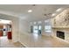 Open living area with a view into the kitchen and a stone fireplace at 3709 Wilderness W Blvd, Parrish, FL 34219