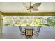 Relaxing screened porch with table and chairs, overlooking backyard at 3709 Wilderness W Blvd, Parrish, FL 34219