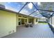 Large screened porch with seating area and view of backyard at 3709 Wilderness W Blvd, Parrish, FL 34219