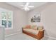 Bright bedroom with a wicker daybed and large window with plantation shutters at 3832 5Th Ne Ave, Bradenton, FL 34208