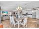 Elegant dining room with a white table and chairs, adjacent to kitchen at 3832 5Th Ne Ave, Bradenton, FL 34208