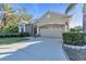 House exterior features a two-car garage and manicured landscaping at 3832 5Th Ne Ave, Bradenton, FL 34208