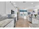 Bright kitchen with white cabinets, granite counters, and tile backsplash at 3832 5Th Ne Ave, Bradenton, FL 34208