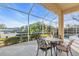 Relaxing screened patio with table and chairs, overlooking canal and pool at 3832 5Th Ne Ave, Bradenton, FL 34208