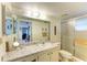 Clean bathroom with marble vanity, shower, and ample storage at 390 301 W Blvd # 11D, Bradenton, FL 34205