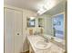 Bathroom with a marble countertop, large mirror, and a shower at 390 301 W Blvd # 11D, Bradenton, FL 34205