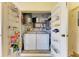 Shared laundry with washer, dryer, and shelving at 390 301 W Blvd # 11D, Bradenton, FL 34205