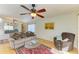 Living room featuring hardwood floors, comfy seating and ceiling fan at 390 301 W Blvd # 11D, Bradenton, FL 34205