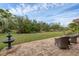 Relaxing backyard patio with seating area, fountain, and lush landscaping at 395 W Rossetti Dr, Nokomis, FL 34275