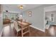 Bright dining room with wooden table and view into living area at 395 W Rossetti Dr, Nokomis, FL 34275