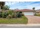 House exterior with landscaped yard and paver driveway at 395 W Rossetti Dr, Nokomis, FL 34275