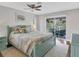 Main bedroom with a view of the backyard and access to a screened porch at 395 W Rossetti Dr, Nokomis, FL 34275