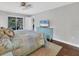 Main bedroom with a light teal bed frame and access to a screened porch at 395 W Rossetti Dr, Nokomis, FL 34275