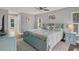 Spacious main bedroom with a light teal bed frame and plenty of natural light at 395 W Rossetti Dr, Nokomis, FL 34275