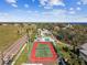 Aerial view showing tennis court, pool, and surrounding community at 4338 14Th Street Cir, Palmetto, FL 34221